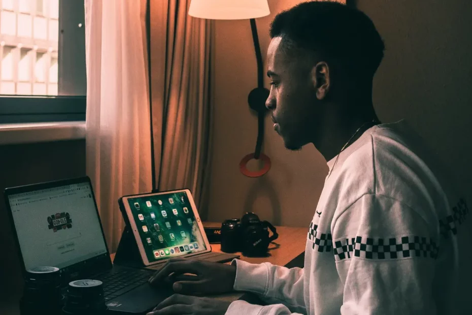 person at desk working on laptap